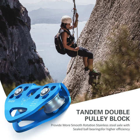 Climber using Beefy Built Tough Zip Line Pulley Tandem Speed Double Pulley 30KN 6700LBS Breaking Strength For 1/4 5/16 3/8 1/2 Inch Cable Backyard Zipline Hauling Rigging And Commercial Use on a cliff.