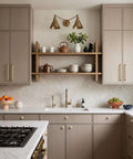 Modern kitchen with light wood cabinets and brass hardware, featuring white backsplash and minimalist decor.