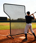 Player using Z Screen Pitching Net 5x7 Ft Portable Baseball Backstop for backyard and field training with strike zone