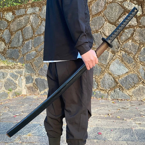Person holding 41 Inch Polypropylene Katana Sword For Training With Black Scabbard High Toughness Practice Blade