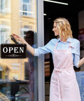 Person hanging an Open Closed Sign For Biz 12x6.7 Inches Waterproof Double Sided Hanging Sign That Says Come In Or Closed With Hours Flip for Stores.