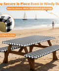 Six Foot Picnic Table Cover With Bench Covers Set All Weather Dual Layer Waterproof Tablecloth With Windproof Elastic Edging Includes Drawstring Bag Washable RV Camping Accessories 72x30 Inch Table Cover And 72x12 Inch Bench Covers Black Checkered in use at beach setting with kite flying