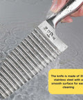Crinkle cutter knife, stainless steel with a wavy blade, close-up view held under running water.