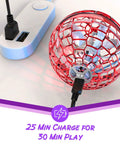Hand Operated Flying Orb Drone charging via USB cable showing red spherical design with text '25 Min Charge for 30 Min Play'