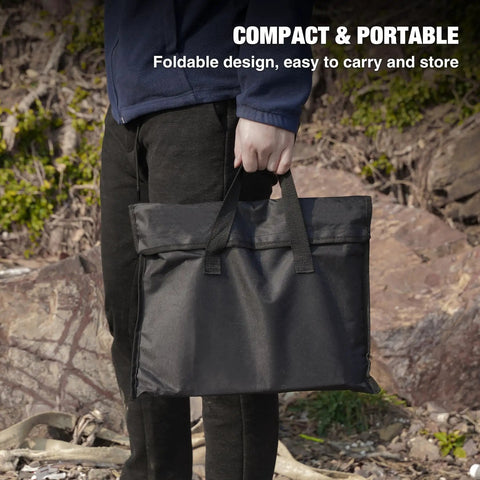 Person holding bag for Portable 20 Inch Stainless Steel Wood Burning Fire Pit With Folding Grill And Carry Bag Ultra Compact Travel Ready Stows To About One Point Two Inches Weighs About Six Lbs Ideal For Camping Picnics Backpacking Beach Trips And Outdoor Heating