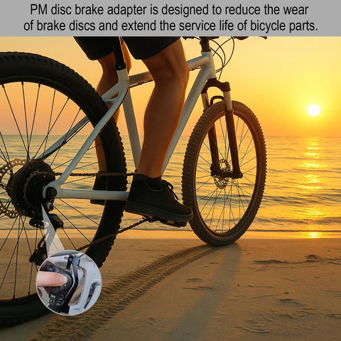 Cyclist on a beach using bike with PM disc brake adapter, designed to reduce brake wear, sunset background