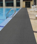 Drainage Non Slip Floor Mat For Wet Areas 3 By 20 Feet Heavy Duty PVC Anti Fatigue Rug installed beside a swimming pool
