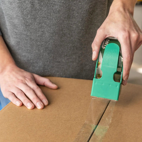 Person using EZ Start Clear Packing Tape Refills For Shipping Moving And Storage 6 Rolls 1.88 Inch By 55 Yards on a box
