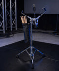 Killer Double Braced Snare Drum Stand With Stick Sleeve, showcasing heavy-duty rubber tripod for stability in garage jams.