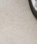 Close-up of water beads on concrete surface with tire, showcasing Deep Penetrating Concrete Sealer With Water Repellent Silane Siloxane.