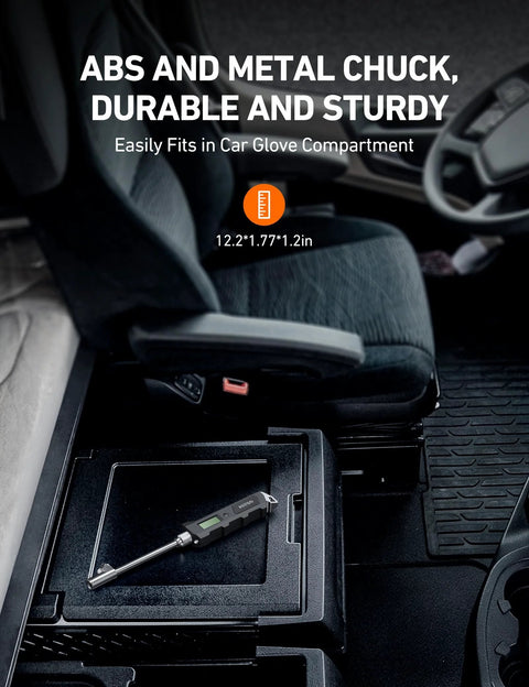 AstroAI digital tire pressure gauge, black with LCD, resting in car center console cubby