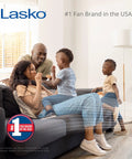 Family enjoying cool air from Lasko fan, #1 fan brand in USA, relaxing on sofa in bright living room.