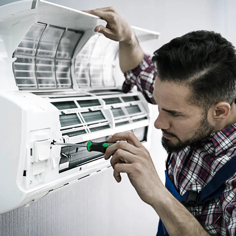 Man using Magnetic Screwdriver Set With Slotted Phillips And Star Bits, Pro Grade S2 Steel Shafts, ergonomic handle, on AC unit.