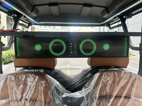 2026 Model 4 Plus 2 Seater Electric Golf Cart With 48V Lithium Ion Battery Long Range And 14 Inch Off Road Tires Solid Black audio system view with green lights, mounted above seats.