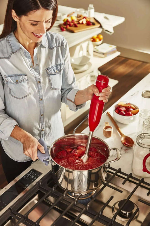 Limited Edition Queen Of Hearts Corded Hand Blender In Bold Passion Red Boasts A Non Slip Soft Grip Handle in use.