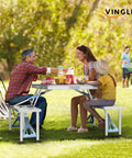 Family enjoying meal at 4 Ft Folding Camping Picnic Table Set With Seats And Umbrella Hole, Grab-And-Go Suitcase-Style for RVs