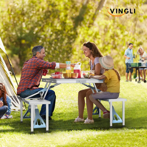Family enjoying meal at 4 Ft Folding Camping Picnic Table Set With Seats And Umbrella Hole, Grab-And-Go Suitcase-Style for RVs