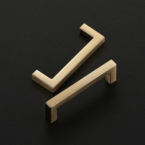 Two Champagne Bronze Slim Cabinet Handles displayed on a dark background, part of a 10 Pack Solid Square Bar Drawer Pulls for Kitchen Cabinets.