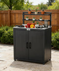 Outdoor Potting Bench With Storage Cabinet And Stainless Steel Work Surface Garden Workstation Raised Edge Top Adjustable Shelf And Removable Hutch For Patio Balcony And Outdoor Workspace Black in garden setting.