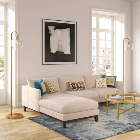 Living room with Arc Floor Lamp With Glass Shade In Brass And White Milk Glass, sleek modern reading light near a beige sofa and brass table.