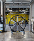 Crush The Summer Heat With This 6 Foot Industrial Mobile Floor Fan Featuring OSHA Certified Safety Cage in a gym setting.