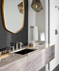 Modern bathroom with marble sink and mirror, showcasing luxury design elements and gray hexagonal tile wall.