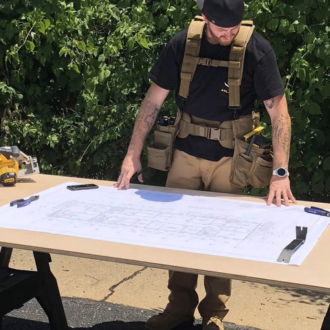 Worker with blueprint wearing Comfort Tuff V2 Heavy Duty Suspenders For Workwear One Size Fits Most Coyote USA Made Rugged Construction