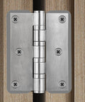 Door Hinge Shims 0.035 Inches, 15 Pack Laser Cut Stainless Steel Kit with brushed silver finish installed on a door hinge