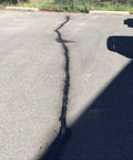 Sealed crack in parking lot using Pro Grade Premium Asphalt Crack Sealer Tape For Parking Lots Rubberized Hot Filler Joint Sealant Waterproof 4 Inch By 50 Foot Black Great For Concrete And Masonry Pavement Repairs
