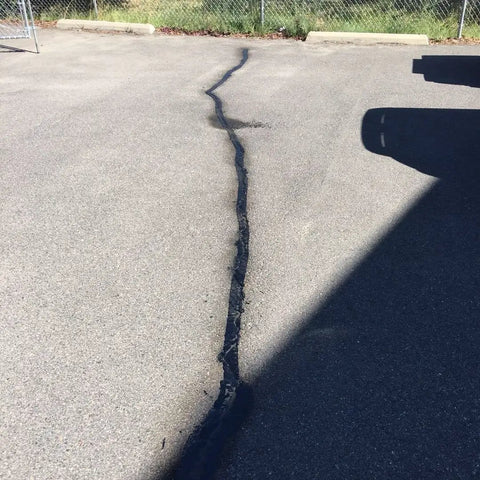 Sealed crack in parking lot using Pro Grade Premium Asphalt Crack Sealer Tape For Parking Lots Rubberized Hot Filler Joint Sealant Waterproof 4 Inch By 50 Foot Black Great For Concrete And Masonry Pavement Repairs