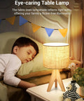 Boho Wood Tripod Table Lamp With Linen Fabric Shade For Nightstand Or Bedside Use Cozy Warm Glow For Living Room Bedroom Nursery Or Kids Room Fourteen Point Two Inch Tall With Simple On Off Switch next to sleeping child