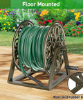 Heavy Duty Garden Hose Reel With Wall And Floor Mount Decorative Hose Holder And Winder For Outdoor Storage Built Tough Steel Construction Holds 200 Feet Of Five Eighths Inch Hose Not Included Keeps Yard Neat And Tidy, shown floor mounted with non-skid rubber boots in a garden setting.
