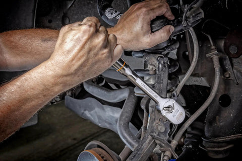 Person using the One Half Inch Drive Teardrop Ratchet With Full Polish Chrome Finish, 120XP Heavy Duty Workhorse on car machinery.