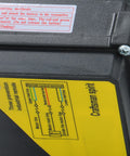 PA400 electric hoist housing; black plastic case with yellow wiring diagram label and a screw head.