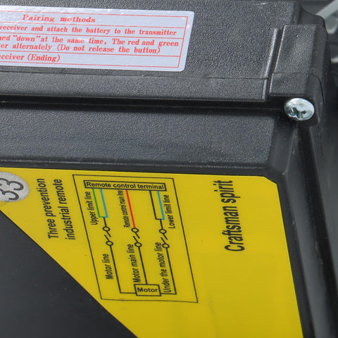 PA400 electric hoist housing; black plastic case with yellow wiring diagram label and a screw head.