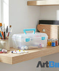 Essentials Lift Out Tray Box For Arts And Crafts Supplies Portable Organizer with handle, clear aqua, on shelf with art tools