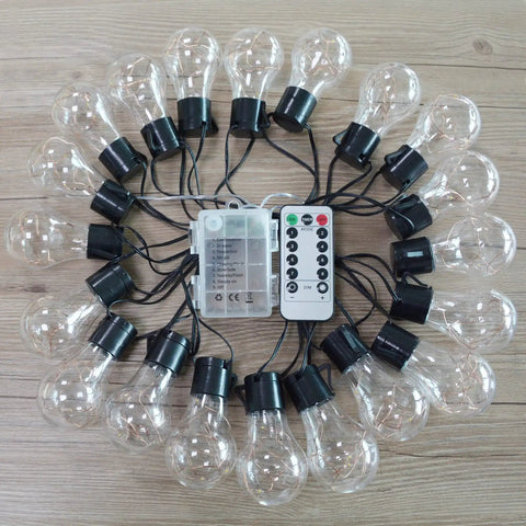 Battery Operated 25 Feet 100 LED Warm White Hanging String Lights With 20 Bulbs Remote Dimmable Eight Modes Memory Timer Waterproof And Shatterproof For Indoor Outdoor Decor Perfect For Bedroom Patio Balcony Home And Christmas Party displayed on wooden surface