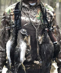 Rugged Paracord Bird Tote Carrier With 12 Drop Slip Ring System holding ducks on a camouflaged hunter's chest for easy carry.