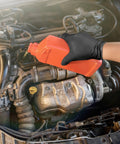 Hella Durable Black Nitrile Safety Gloves With Sick PyraGrip Texture For Superior Traction On Greasy Jobs pouring oil into a car engine.