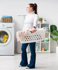 Person holding a 50L Laundry Hamper Set With Built In Comfort Handles 3 Pack White Plastic Baskets With Ventilation Holes