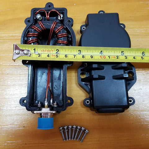 3-54 MHz 1:1 Current Balun For Dipole Antennas, open casing view with toroid core and screws on wooden table