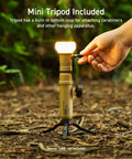 Person using Go-To Rugged Outdoor Camping LED Lantern With Mini Tripod Dimmable USB Powered Soft Light on forest floor
