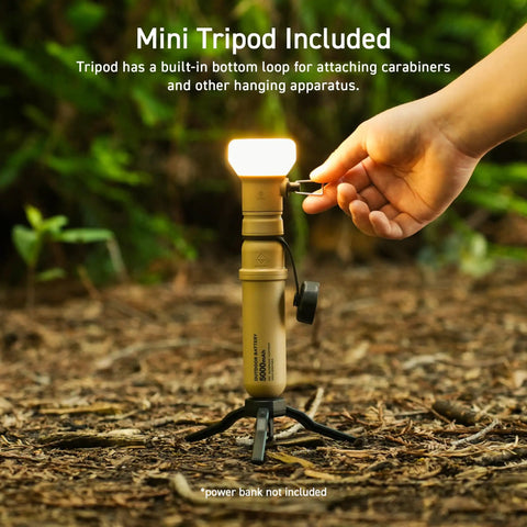 Person using Go-To Rugged Outdoor Camping LED Lantern With Mini Tripod Dimmable USB Powered Soft Light on forest floor
