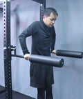 Man using Nordic Leg Roller For Rack Mounted Pro Grade Home Gym, Bulgarian Split Squat Accessory And Nordic Hamstring Curl Attachment