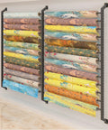 Heavy Duty Wall Mount Fabric Roll Storage Rack With Quick Snap Crossbars To Keep Your Wrapping Paper Ribbons And Craft Spools Totally Sorted And No Mess At All with colorful rolls displayed.
