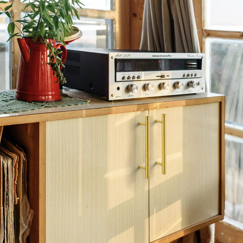 Solid Brass Kitchen Cabinet Pulls Set of 6 in Polished Gold with Hammered T-Bar Handles on a wooden cabinet