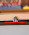 Top Shelf 1/8 Inch Radius Roundover Router Bit With Sharp Carbide Cutting Tips and Rock Solid Bearing Guide in use on a woodworking table.