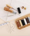 Pro Grade Leather Sewing Kit With Waxed Thread And Hand Sewing Machine Portable Stitching Tool For DIY Leather Repair And Craft With 11 Accessories 3 Needle Sizes 2 Spools And 6 Color Threads displayed with tools and threads.