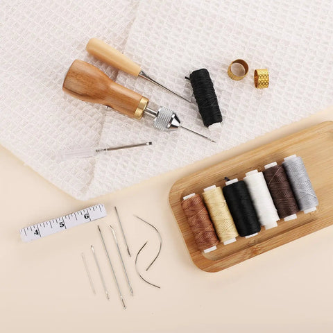 Pro Grade Leather Sewing Kit With Waxed Thread And Hand Sewing Machine Portable Stitching Tool For DIY Leather Repair And Craft With 11 Accessories 3 Needle Sizes 2 Spools And 6 Color Threads displayed with tools and threads.