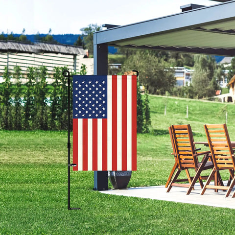 American Flag Garden Flag 12 Inch By 18 Inch Double Sided Patriotic Yard Decor for garden and lawn perfect Fourth of July Memorial Day outdoor display fade resistant nylon with chairs in the background.